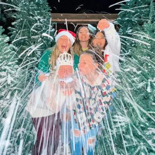 students enjoying the fake snow at Concordia Christmas