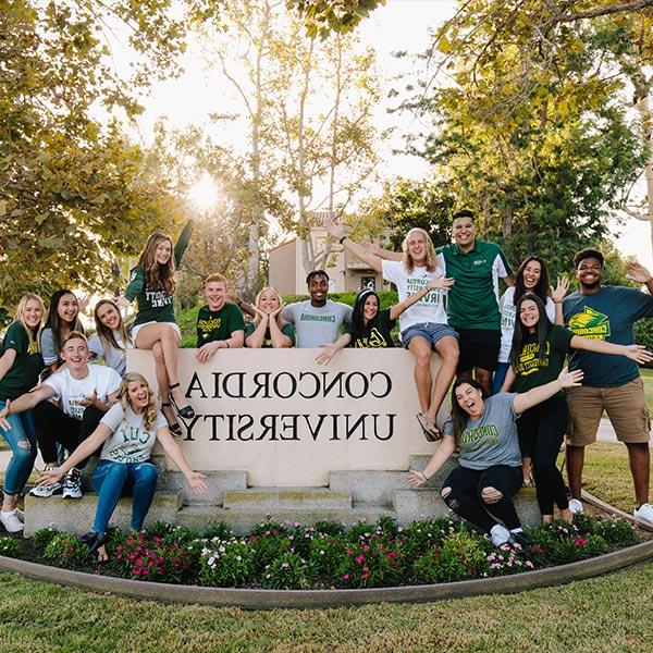 Group of students posing in front of Concordia University sign
