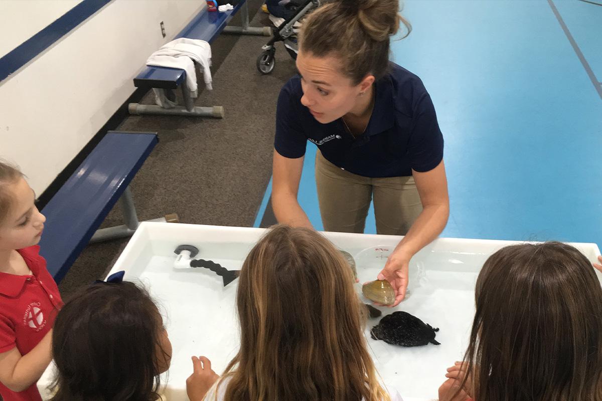 Female teaching children about the Marine Lab