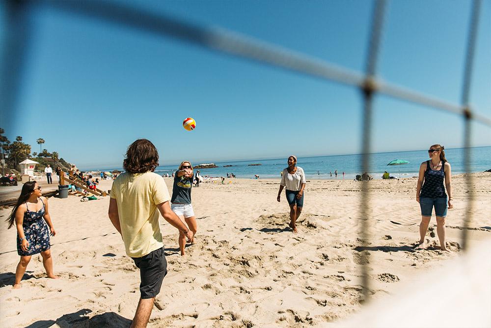 Students enjoy a game of beach volleyball at Laguna Beach.