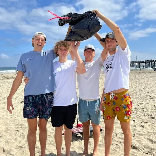 students with a bag of trash