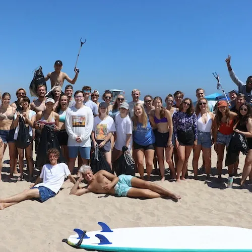 students in a group photo at the beach