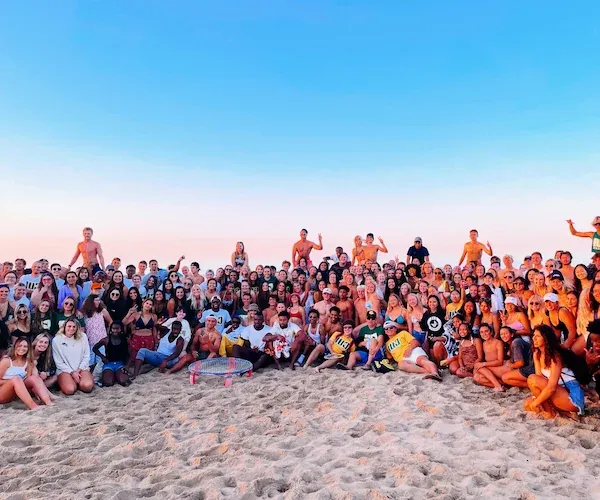 Student group photo at the beach bash